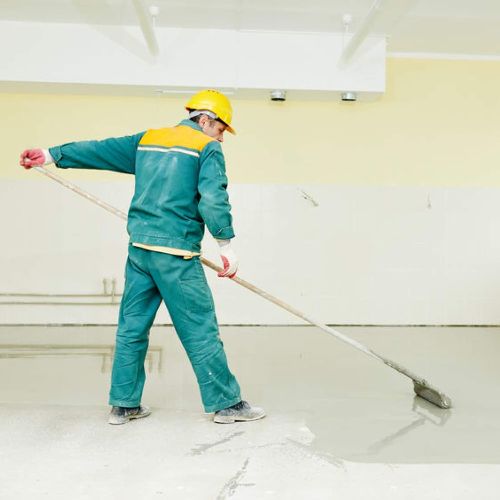 Painter using roller to paint floor